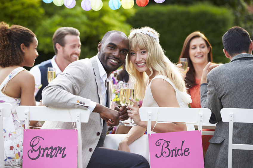 bride and groom enjoying meal at wedding reception